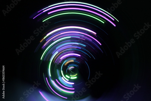 A long exposure photograph. Light painting photography, vibrant fairy lights against a black background
