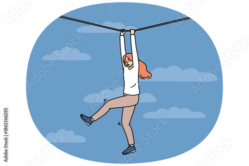 Frightened woman faces risk and danger as she navigates way along rope suspended high in sky. Young girl experiences fear and horror but fights challenge on path to success despite risk