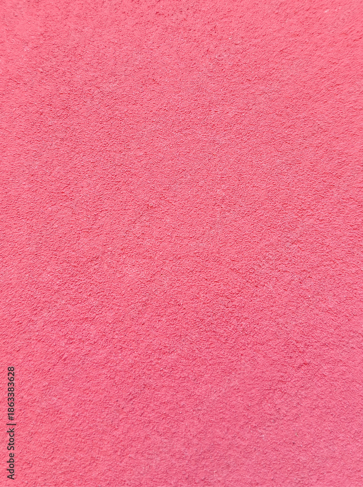 Fototapeta premium Pink concrete wall texture background with rough painted surface