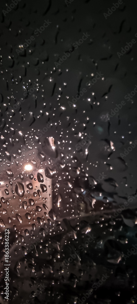 Fototapeta premium Raindrops on glass with soft evening light