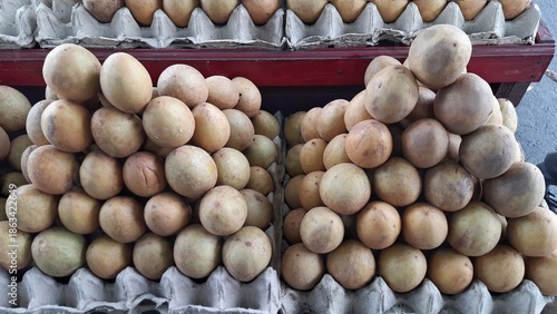 Sawo or Sapodilla Fruits Stacked in Market Display Indonesia