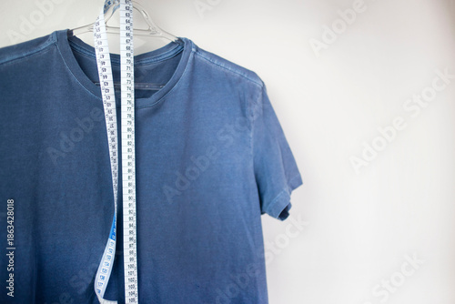 Tableau sur toile Shirt with measure tape in white background with copy space