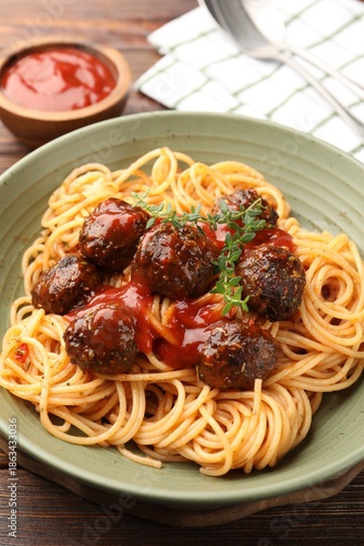 Delicious pasta with meatballs in bowl on table, closeup © New Africa