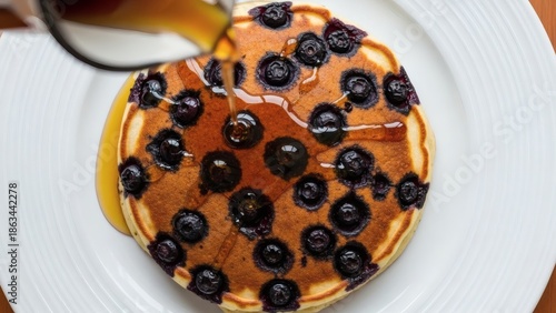 Wallpaper Mural A stack of fluffy pancakes topped with fresh blueberries and syrup on a white plate Torontodigital.ca