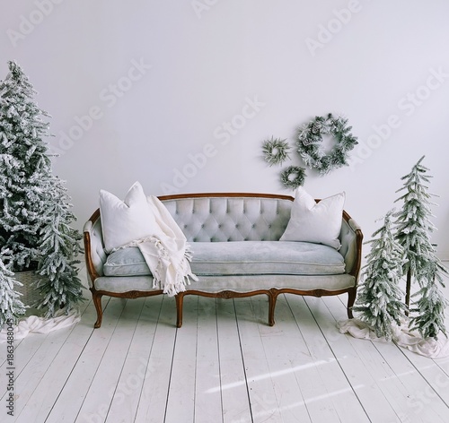 christmas trees and white sofa in a living room
