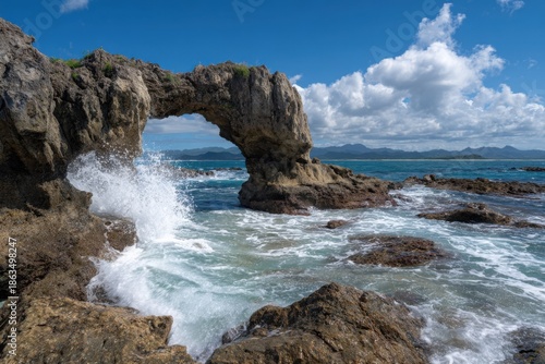 Coastal archway under a vibrant blue sky