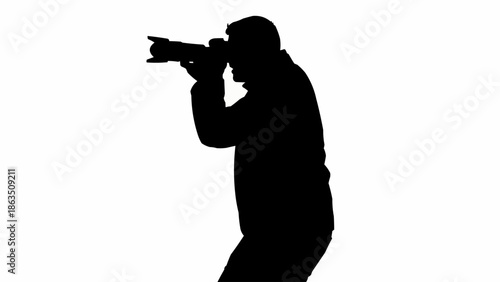 Silhouette of a photographer holding a camera and taking a picture.
