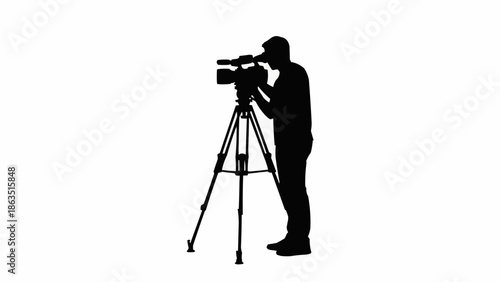 Silhouette of a videographer operating a professional video camera on a tripod.