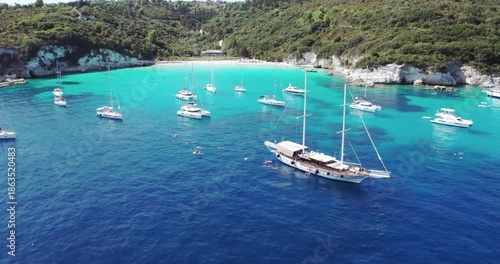 Aerial drone view of luxury yacht boats at the breathtaking Voutoumi beach, Antipaxos Greece