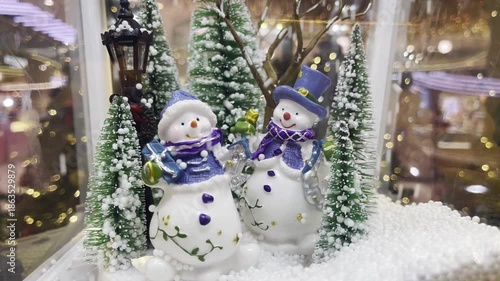 Christmas toy box with tree Snow and dolls circulate inside the glass. 