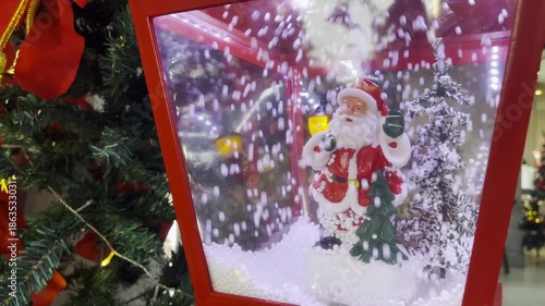 Christmas toy box with tree Snow and dolls circulate inside the glass. 