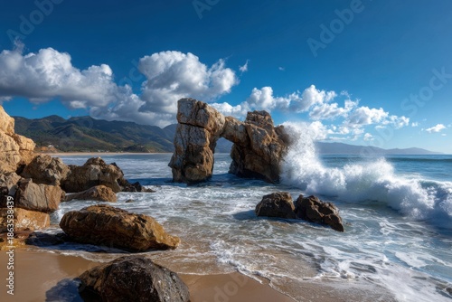 Dramatic coastal scene with a rock arch and crashing waves