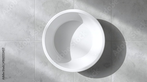 Minimalist Round White Bathtub on Concrete Tile Floor, Top View