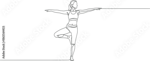 Woman practicing yoga in tree pose