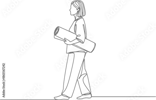 Woman walking with yoga mat and bag