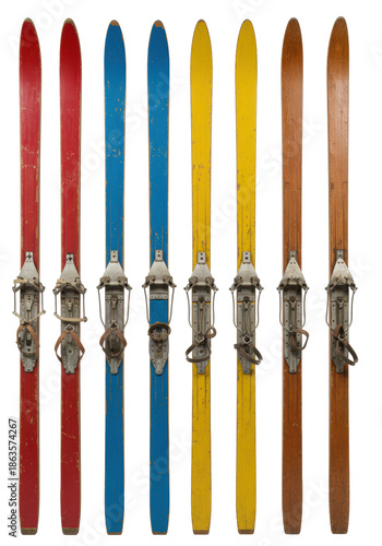 Six colorful vintage wooden alpine skis (red, blue, yellow) from the 1940s on a transparent studio background with copy space, showing weathered wood grain and retro bindings, concept of winter sports