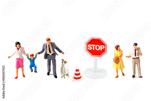 Miniature people with traffic sing on white background.