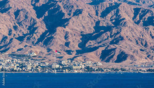 View on the coastal area of Aqaba city with one of the biggest mosque and flag of Arab revolt in Jordan