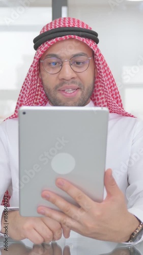 Online Video Talk via Digital Tablet by Muslim Man, vertical video