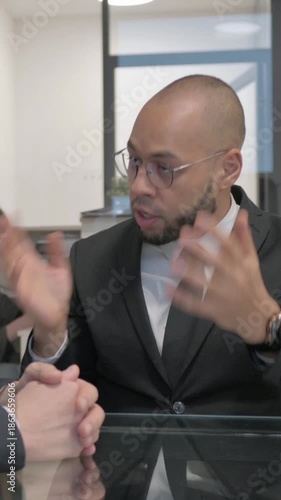 Angry Mixed Race Businessman in Argument with Teammate, vertical video