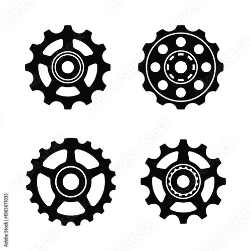 Vector illustration showing a set of four black bicycle gear sprockets in silhouette on white background.