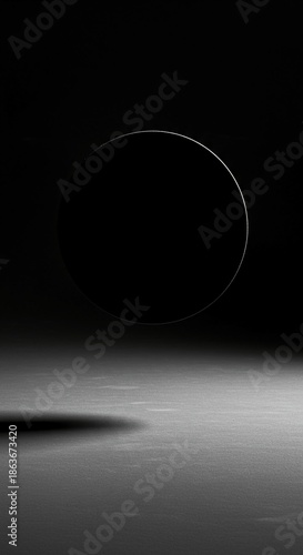 Abstract geometric composition with a single dark circle on a vast, textured gray field emphasizing negative space and shadows, composition, form, modern
