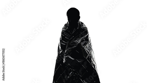 A stark silhouette of a person draped in a shiny dark quilted blanket against a bright white background