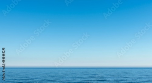 A peaceful wide angle view of the distant blue sky meeting the subtle line of the ocean surface creating a serene natural background texture, template, texture, clean