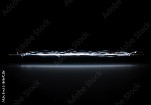 Abstract presentation of faint, fading illumination, leaving a gentle trace of energy across a dark, undefined space, background, dreamy, artistic