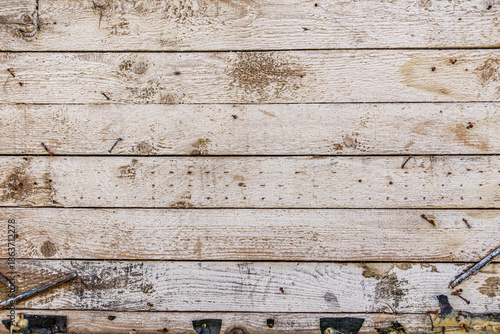 Detailed close up of rustic wooden planks with natural grain, rough texture, scratches, and weathered surface. Perfect background for design projects, vintage decor, carpentry, and creative artwork.