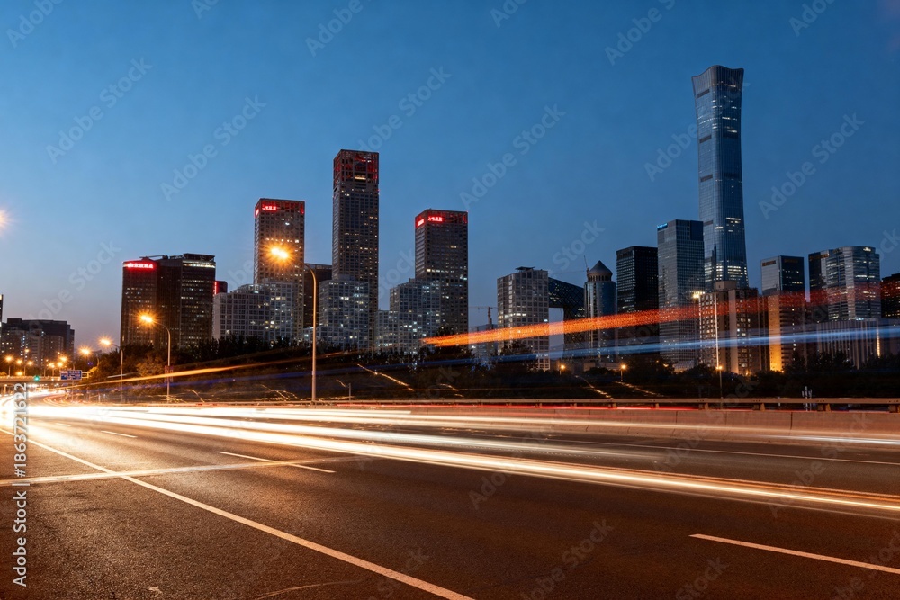 Fototapeta premium City skyline at dusk with light trails