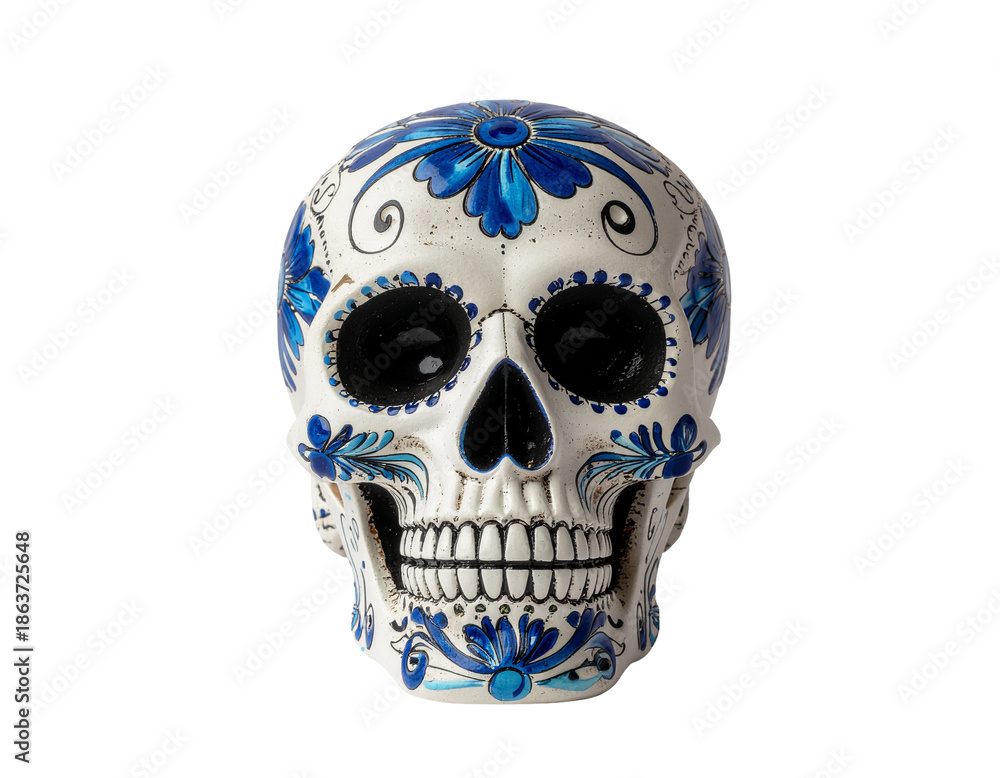 Obraz premium Carved ceramic skull with blue floral patterns on white background for day of the fallen decoration
