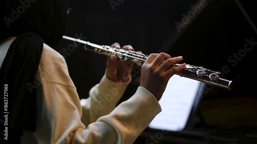 Cinematic Close Up of Musician Playing Silver Flute in rehearsal studio music