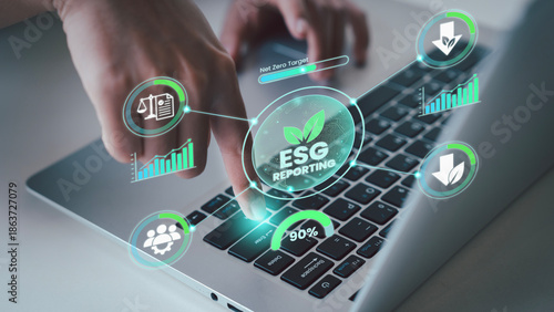 Photos Close up of finger pressing enter on laptop for ESG reporting to finalize sustai