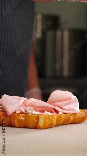 Chef cooking Croissant sandwich, Healthy Breakfast in Cafe or restaurant. croissant dish. Fresh pastry. Vertical 4 k video