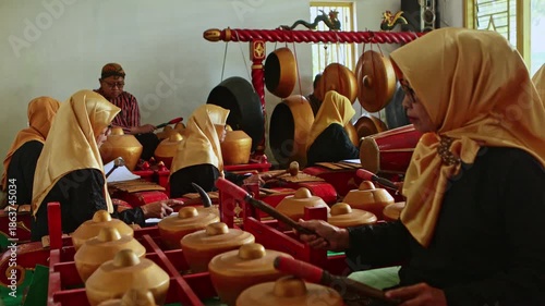 Indonesian women playing traditional javanese gamelan music