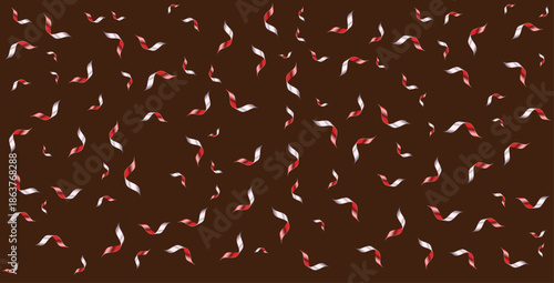 A dark chocolate background covered in swirling red and white candy pieces