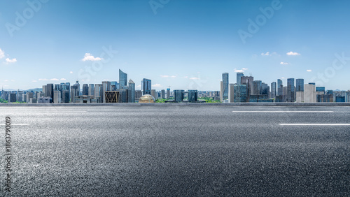 Obraz na płótnie Empty asphalt road and modern city skyline with office buildings.