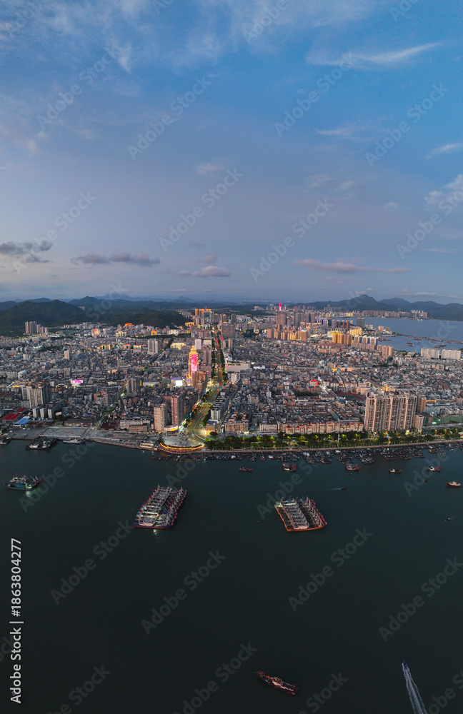 Fototapeta premium Aerial shot of Xinli Building in Shanwei Port, Shanwei City, Guangdong Province, captured at sunset