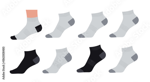 Multiple pairs of ankle length socks in various shades of gray and black with one shown on a human foot.