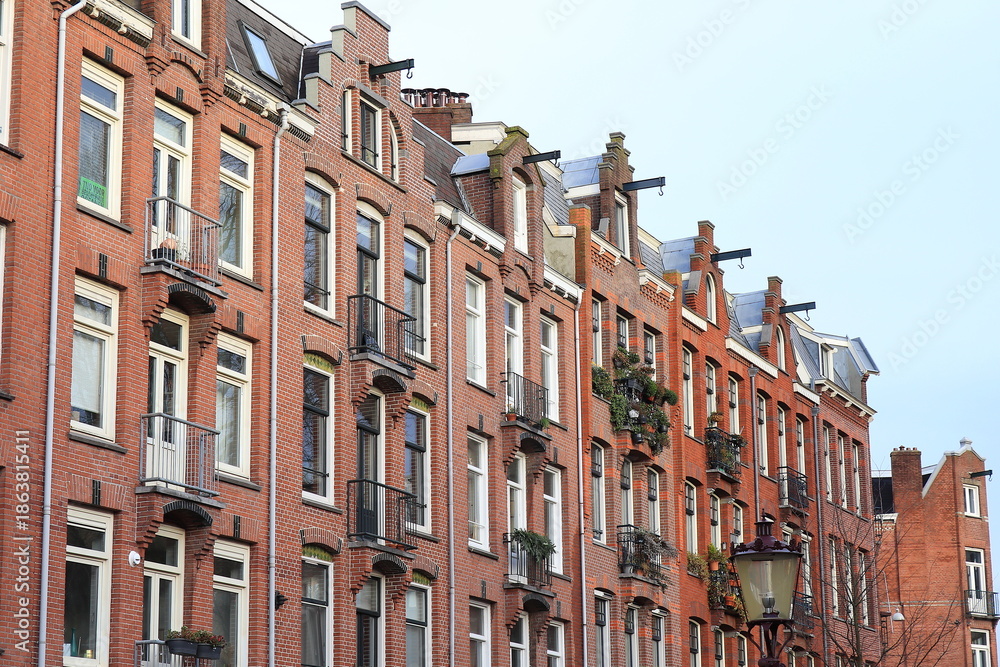 Fototapeta premium Red Brick House Facades in Amsterdam, Bellamyplein Square, Netherlands