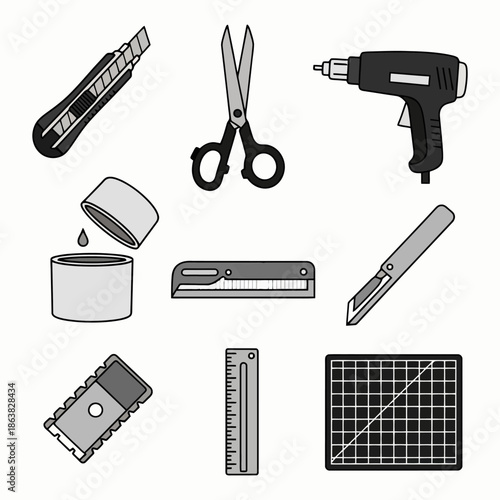 A collection of crafting and cutting tools, including a utility knife, scissors, a hot glue gun, a stapler, a ruler, and a cutting mat.