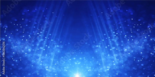 Blue abstract fiber optics background featuring a bright winter design with glowing light spots and starry particles across a shining holiday backdrop