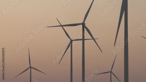 A silhouette video of wind turbines at sunset.