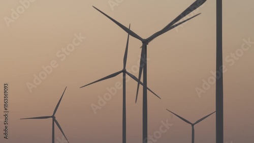 A silhouette video of wind turbines at sunset.
