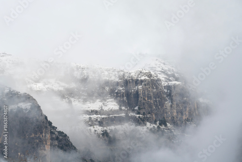 Foggy snow mountains in winter landscape