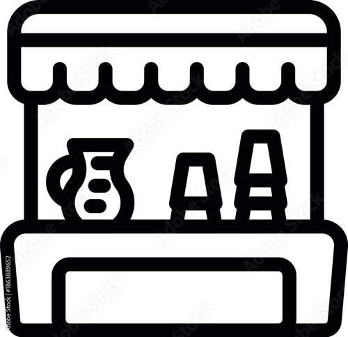 Outdoor kiosk at a local market selling beverages with pitchers and cups displayed on the counter