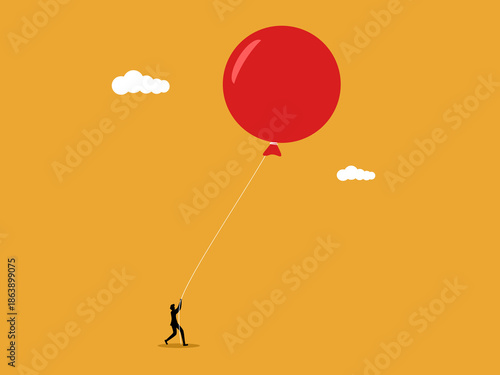 businessman held the balloons back to prevent them from floating away