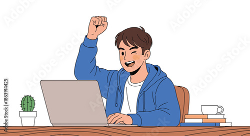 Happy young man celebrating success with a fist pump while working or studying on his laptop computer at a wooden desk.