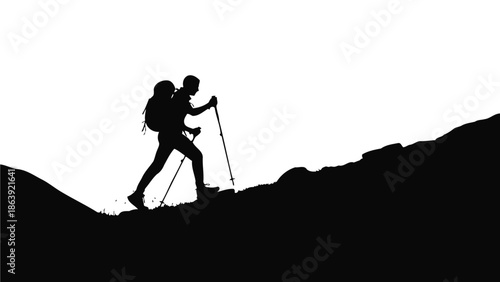 Silhouette of a determined hiker ascending a steep mountain slope using trekking poles against a bright sky